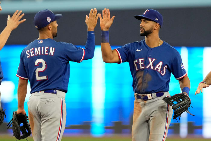 Sep 11, 2023; Toronto, Ontario, CAN; Texas Rangers second baseman Marcus Semien (2) and center fielder Leody Taveras (right) celebrate a win over the Toronto Blue Jays during the ninth inning at Rogers Centre. Mandatory Credit: John E. Sokolowski-USA TODAY Sports